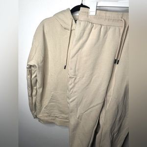 Males jumpsuit cream color in a size Large